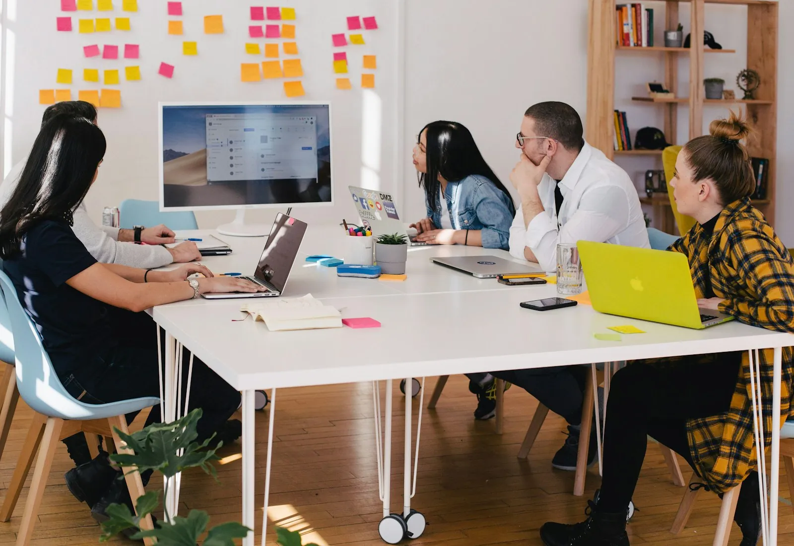 A supportive, diverse team collaborating in a bright modern office